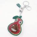 Detail of cartoon avocado keychain with sparkling rhinestones and green leather tassel - Red