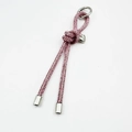 Macro detail of luxury pink rhinestone knotted keychain with heart charm and metal ring - Pink