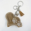 Detail of bear paw heart keychain with sparkling rhinestones, tassel, and bell accessory - Coffee