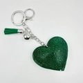 Sparkling green crystal heart keychain with silver tassel and bell on white background - Dark Green