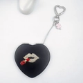 Black leather heart-shaped keychain mirror with rhinestone lips and clover charm - Black