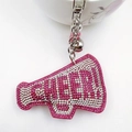 Macro detail of pink rhinestone megaphone keychain with silver bell and clasp - Rose Red & White