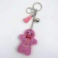 Pink rhinestone gingerbread man keychain with matching tassel and silver bell detail - Pink