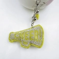 Detailed view of neon yellow megaphone keychain with rhinestones, bell, and leather tassel - Yellow