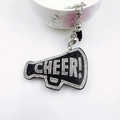 Close-up of a rhinestone megaphone keychain with CHEER text and black leather tassel - White and Black