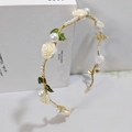 Close-up of golden headband featuring white resin roses and elegant faux pearls - Resin Rose Style / Milky White