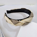 Detalle de diadema de tela a cuadros con diseño trenzado y adornos de perlas blancas - Caqui