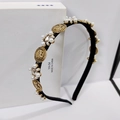 Close-up of Baroque headband with vintage gold coins, white pearls and sparkling crystals - Bronze