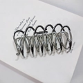 Detailed view of silver wave-shaped metal hair claw clip with smooth alloy finish - Gun Black
