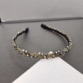 Detailed view of an olive green braided headband with sparkling rhinestone clusters - Gray