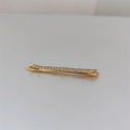 Elegante gouden haarspeld met een rij glinsterende strass-steentjes op een grijze basis - Goud
