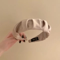 Elegant beige satin pleated headband featuring a handmade label and soft cloud texture - Off White