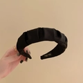 Detail of handmade wide black pleated headband showing fabric texture and inner woven label - Black