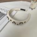 Close-up of handmade cream padded headband with crystal triangles and gold rivets - 8# Triangle Gem Beige