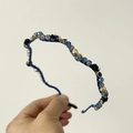Detail of blue headband with faceted crystals and small black fabric flowers decoration - Blue