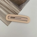 Detailed macro view of a matte cream-colored BB hair clip with elegant hollow design - Flesh Pink