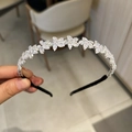 Close-up of sparkling zircon crystal floral headband with silver metallic frame and diamonds - Flower Style