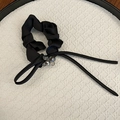 Detail of black satin scrunchie with crystal beads and long ribbons on a white tray - Black with Ribbon
