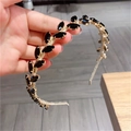 Detail of golden leaf headband featuring black marquise gems in a vintage Greek style - Black