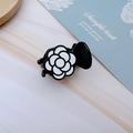 Close-up of elegant camellia hair claw clip with black and white glossy finish texture - White Rose