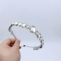 Close-up of luxury silver-tone headband with multi-shape sparkling crystals and gems - Clear