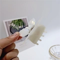Detailed view of white pearlescent acetate butterfly hair claw clip with shell luster - Butterfly Style
