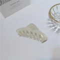 Detailed close-up of a large pearlescent acetate hair claw clip on a white minimalist desk - 10cm / Large Triangle Bead