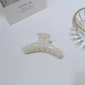 Detail showing pearlescent acetate hair claw clip with iridescent finish on white desk - 9cm / Curved Barrette