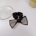 Detail of black satin scrunchie with sparkling rhinestone bow tie showing material texture - Black