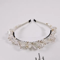 Detail of luxurious crystal headband with handcrafted transparent beads and gold accents - White