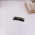 Close-up of a black rectangular hair clip with white pearl flowers and gold gems - Type A BB Clip