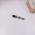 Close-up of vintage baroque hair clip with brown rhinestones and white pearls on black fabric - Style C Hair Clip