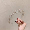 Detail of silver headband featuring multi-faceted crystal flower clusters and star designs - White