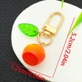 Cute cartoon orange fruit keychain with green acrylic leaf and golden D-ring clasp - Orange Style (ER1495)