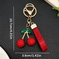 Portachiavi a ciliegia con strass rossi e foglia verde su anello in metallo dorato - Rosso