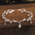 Macro shot of silver leaf headband with shimmering rhinestones and crystal drop pendants - White K/Silver