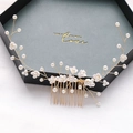 Handmade bridal hair comb with ceramic flowers and pearls on golden wire in a gift box - White