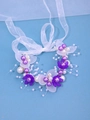 Handgefertigtes Brautstirnband mit lila Blütenakzenten und weißen Organza-Stoffbändern - Lila / Handgelenkband
