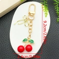 Porte-clés créatif cerise rouge avec nœud doré et breloque feuille verte de 9,2 cm - Style Cerise Nœud Papillon Rouge Or KC (ER1582)