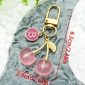 Detail view of pink resin cherry keychain with golden leaf and letter B enamel charm - Rose Pink Letter B (ER1597)