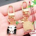 Cute panda metal keychain variant with bamboo leaf charm and gold finish back - Handstand Panda Style (ER1176)