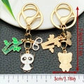 Cartoon panda keychain with bamboo charm in gold metal finish and enamel details - Standing Panda Style (ER1205)