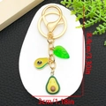 Detail view of avocado keychain dimensions 8.4cm by 3cm with golden lobster clasp and charms - Avocado Leaf Style (ER1612)