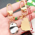 Cute panda metal keychain with bamboo leaves and golden finish for bags or keys - Panda Holding Wood Style (ER1178)