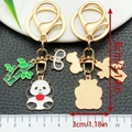 Cartoon panda keychain with red apple and bamboo charms on gold metal ring - Apple Panda Style (ER1208)