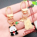 Panda enamel metal keychain with bamboo leaf pendant showing front and back views - Panda Holding Apple Style (ER1183)
