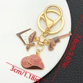 Western style keychain featuring a brown cowboy hat, star bandana, and pistol charms - Brown Cowboy Hat Gun (ER1259)