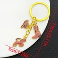 Portachiavi smaltato rosa cowboy occidentale con cavallo cappello e stivali dorati - Marrone (ER1267)