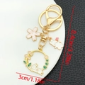 Detailed view showing dimensions of Chinese style rabbit and flower alloy keychain - Lily of the Valley Flower Rabbit Keychain (ER1726)