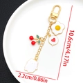 Vue détaillée des pendentifs cœur et œuf sur un porte-clés doré en U avec mesures de taille - Émail Blanc Cerise Œuf Plat Ours (ER1506)